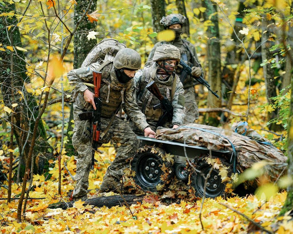 Ukrainian soldiers use a robotic vehicle in a forest