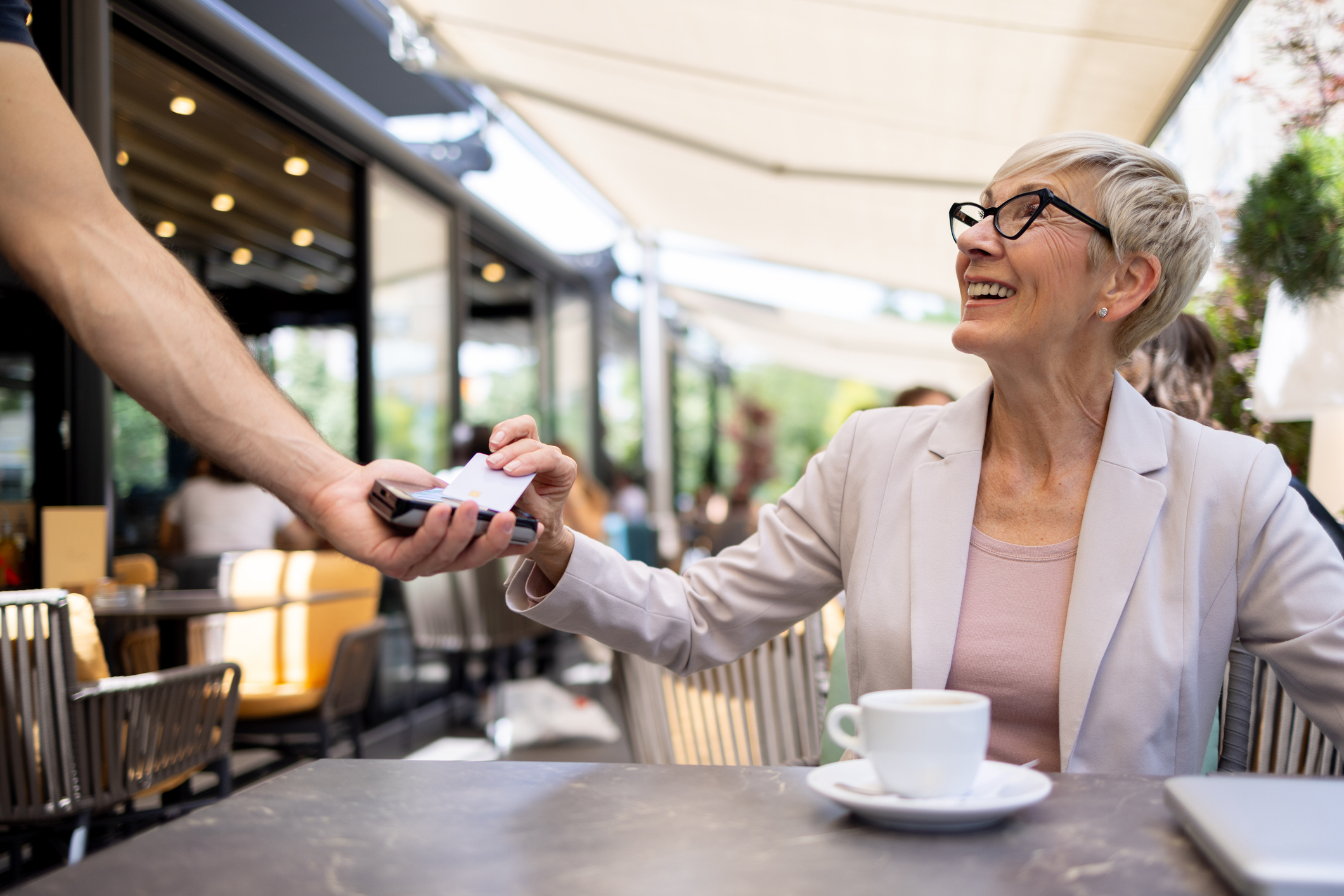 Woman paying for coffee with credit card