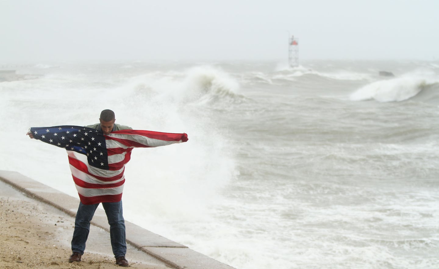Richard Tarter, 54, an ex-marine, flew the American flag at the seawall in Oak Bluffs as Tropical Storm Irene began to hit Martha's Vineyard in 2011. "It's the right thing to do," Tarter said. "During troubled times you can always count on the flag." He also flew the flag during Hurricane Bob. 