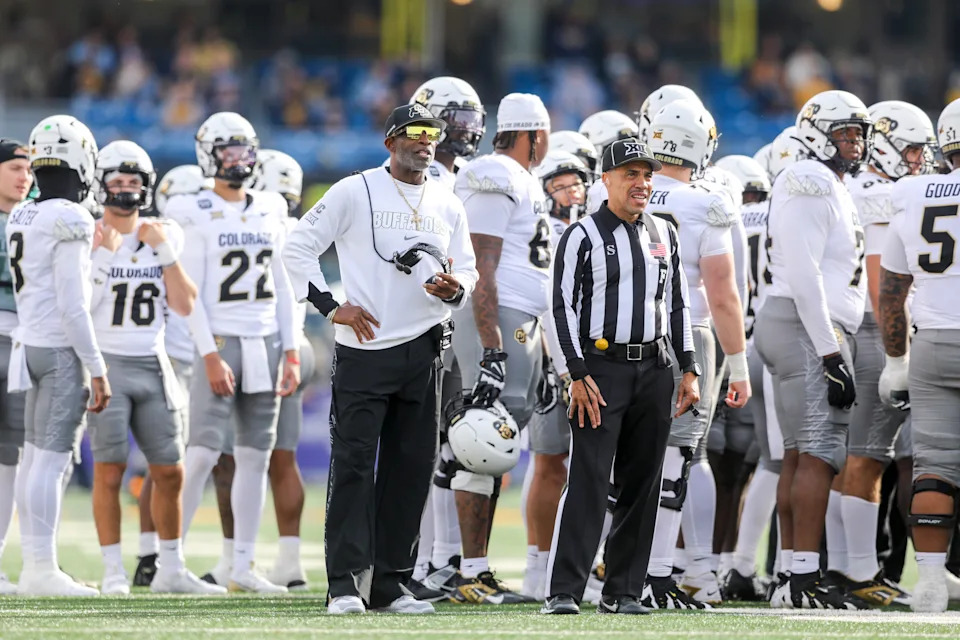 Nov 8, 2025; Morgantown, West Virginia, USA; Colorado Buffaloes head coach Deion Sanders watches the big screen during a replay during the first quarter against the West Virginia Mountaineers at Milan Puskar Stadium. Mandatory Credit: Ben Queen-Imagn Images