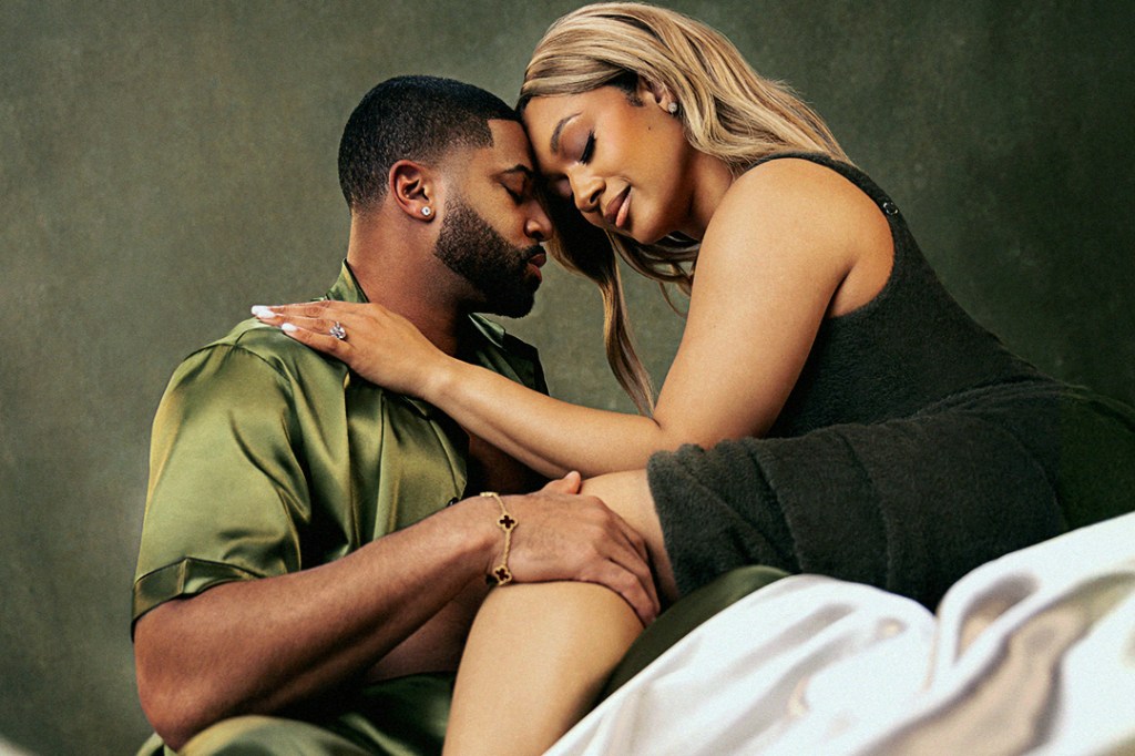 A man and woman, heads touching, looking intimate.