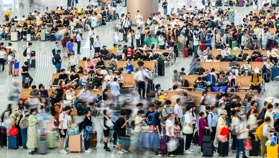 High angle view of many passeners sitting on seats and walking waiting in departure area