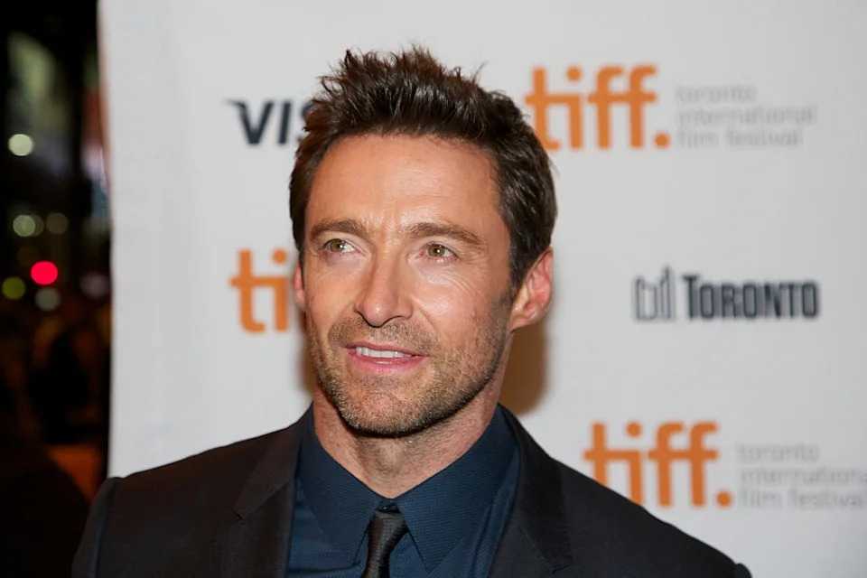 Person in a suit at Toronto International Film Festival event, posing for photos