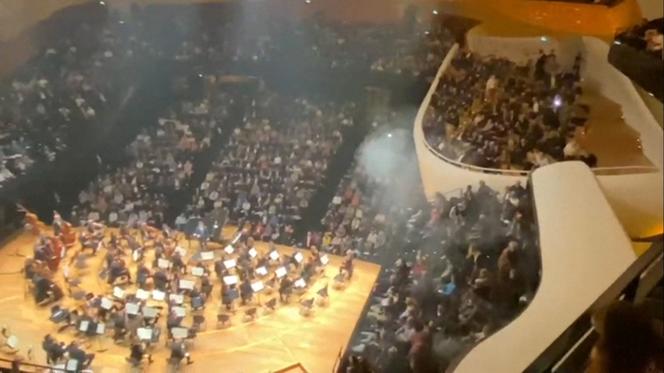 This screenshot taken from a video shows incidents in the Pierre-Boulez Hall of the Philharmonie de Paris concert hall, after a person ignited a smoke bomb during a concert by the Israel Philharmonic Orchestra, on November 6, 2025, in Paris.