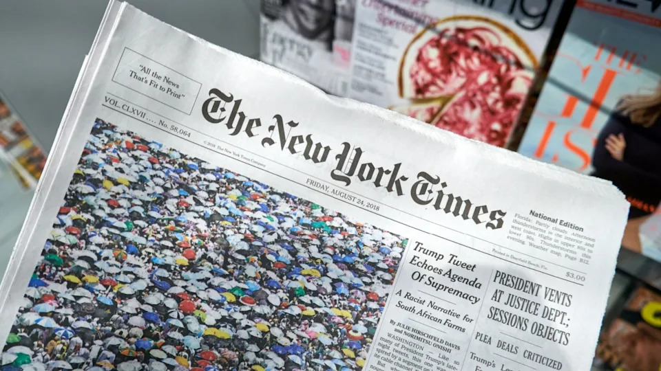 MIAMI, USA - AUGUST 22, 2018: The New York Times newspaper in a hand. The New York Times is a popular American newspaper based in New York City with worldwide influence
