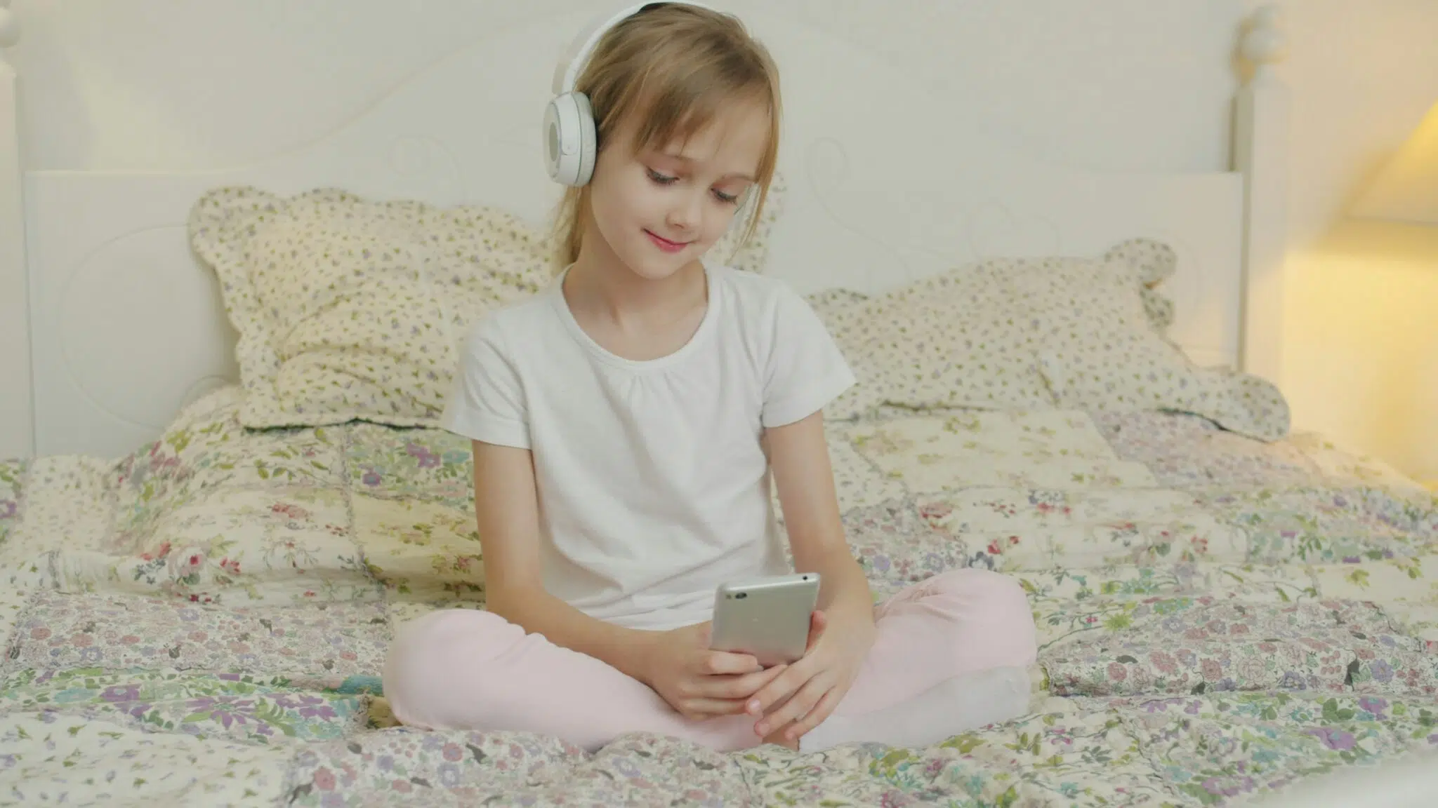 A girl looking at her phone with headphones on