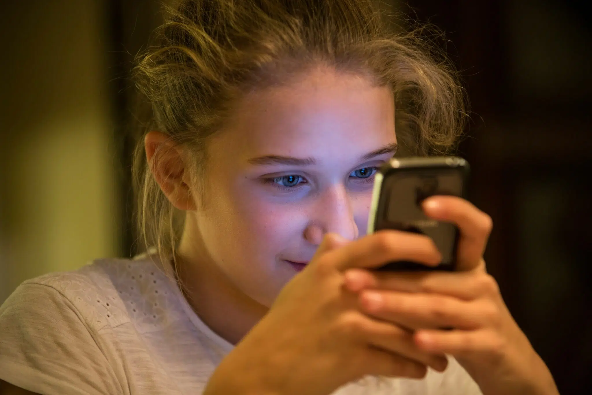 A girl looking at her phone screen