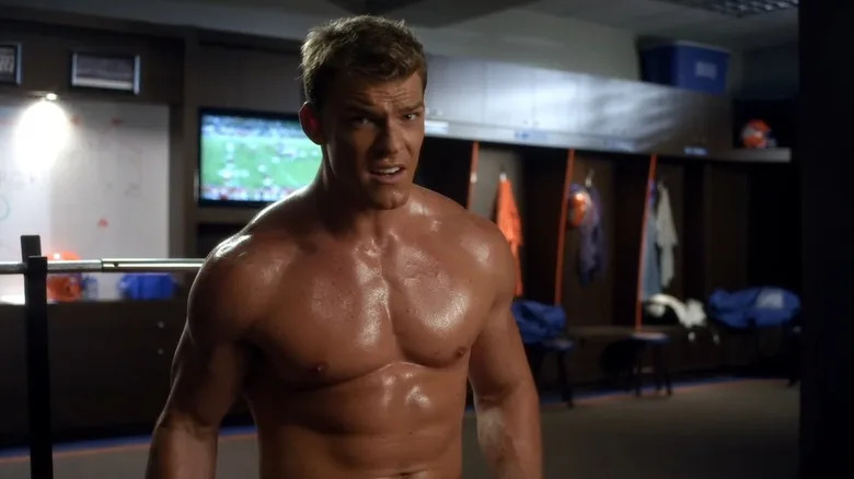 A shirtless Alan Ritchson as Thad Castle in a locker room on Blue Mountain State