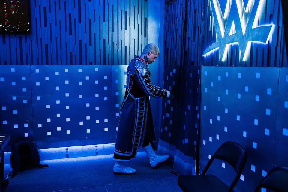 Wrestler walking in blue-lit room from "WWE" documentary