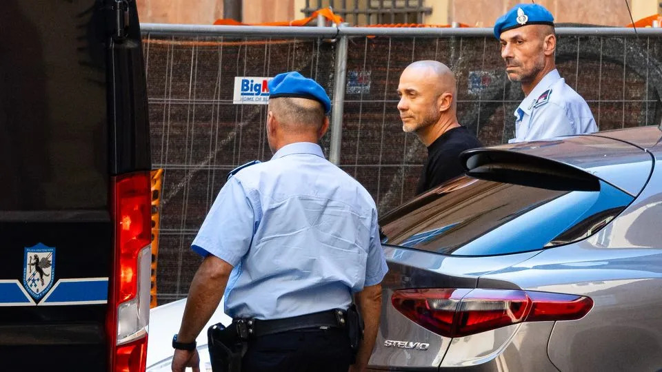 Sehrii Kuznietsov is loaded onto a prison police van to be taken back to jail, after appearing before Italy's Bologna Court of Appeal, which confirmed his arrest on August 22, 2025. - Massimiliano Donati/Getty Images