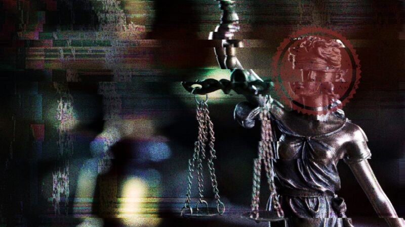 The face of a glitching Lady Justice is covered by a red seal.