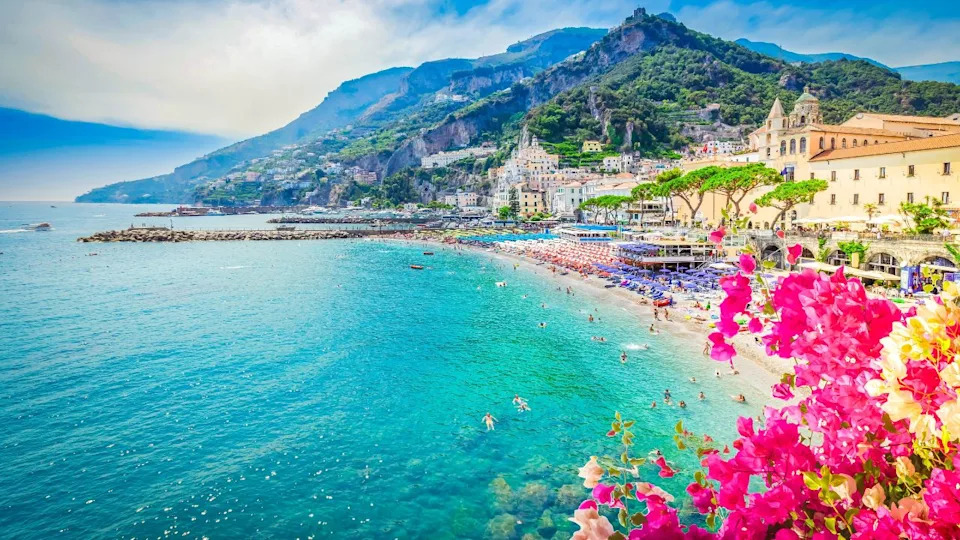 Amalfi town and summer beach with clean blue water and flowers , Italy
