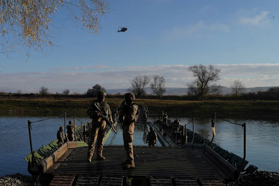 Andreea Campeanu/Reuters - PHOTO: A military helicopter flies above French soldiers during the "Dacian Fall" military exercise in Santimbru, Romania, on Nov. 9, 2025.