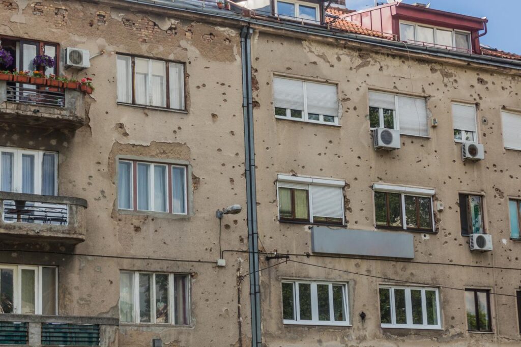 Bullet-riddled walls of a house in Sarajevo, Bosnia and Herzegovina. (Adobe Stock Photo)