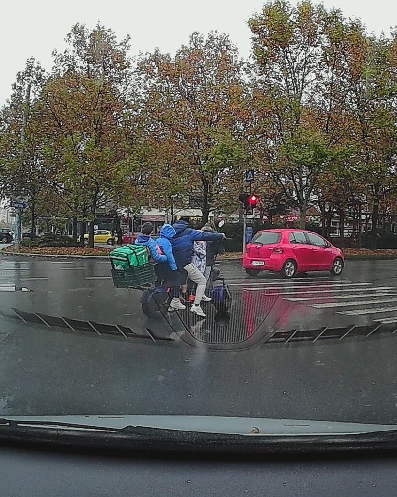 1 man and 4 children on a moped