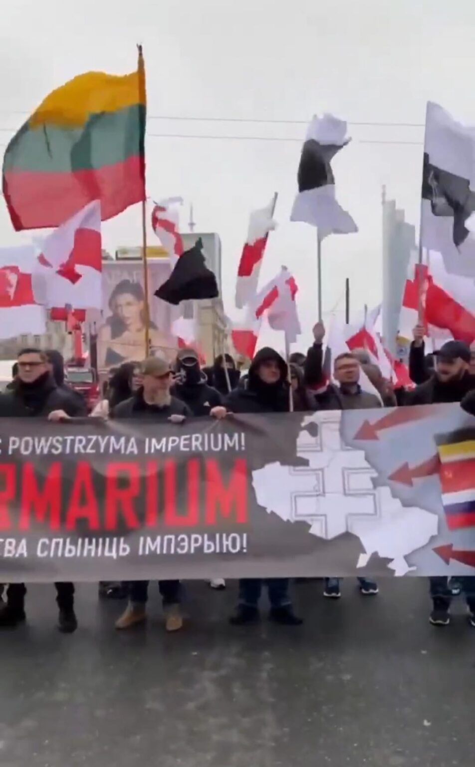 Belarusians with a banner at the independence march "only unity will stop the Intermarum Empire"