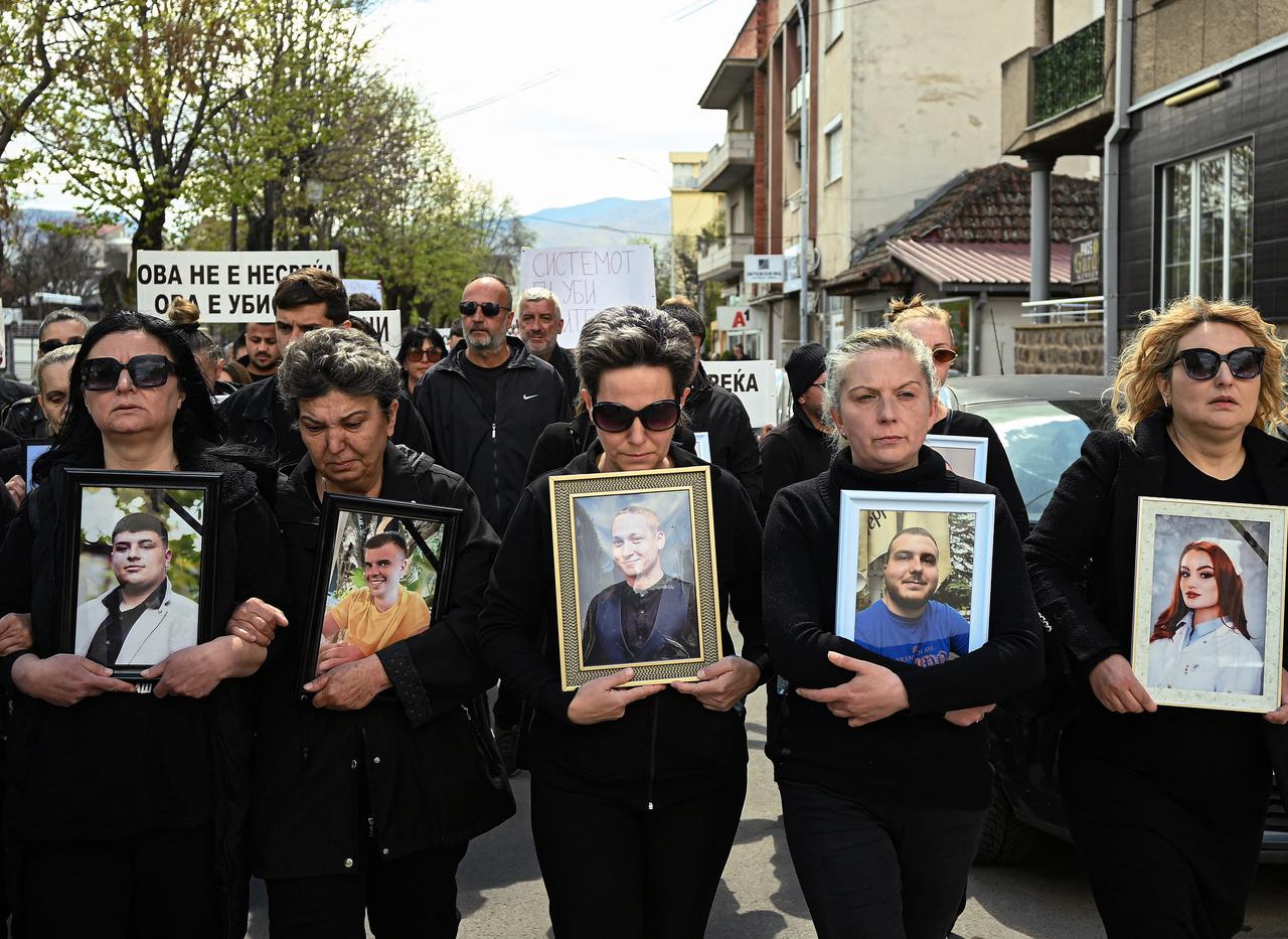 Relatives and loved ones of victims of the Kocani nightclub fire hold portraits of victims as they take part in a march called "Belated Reaction" in Kocani, on April 12, 2025. (AFP File Photo)
