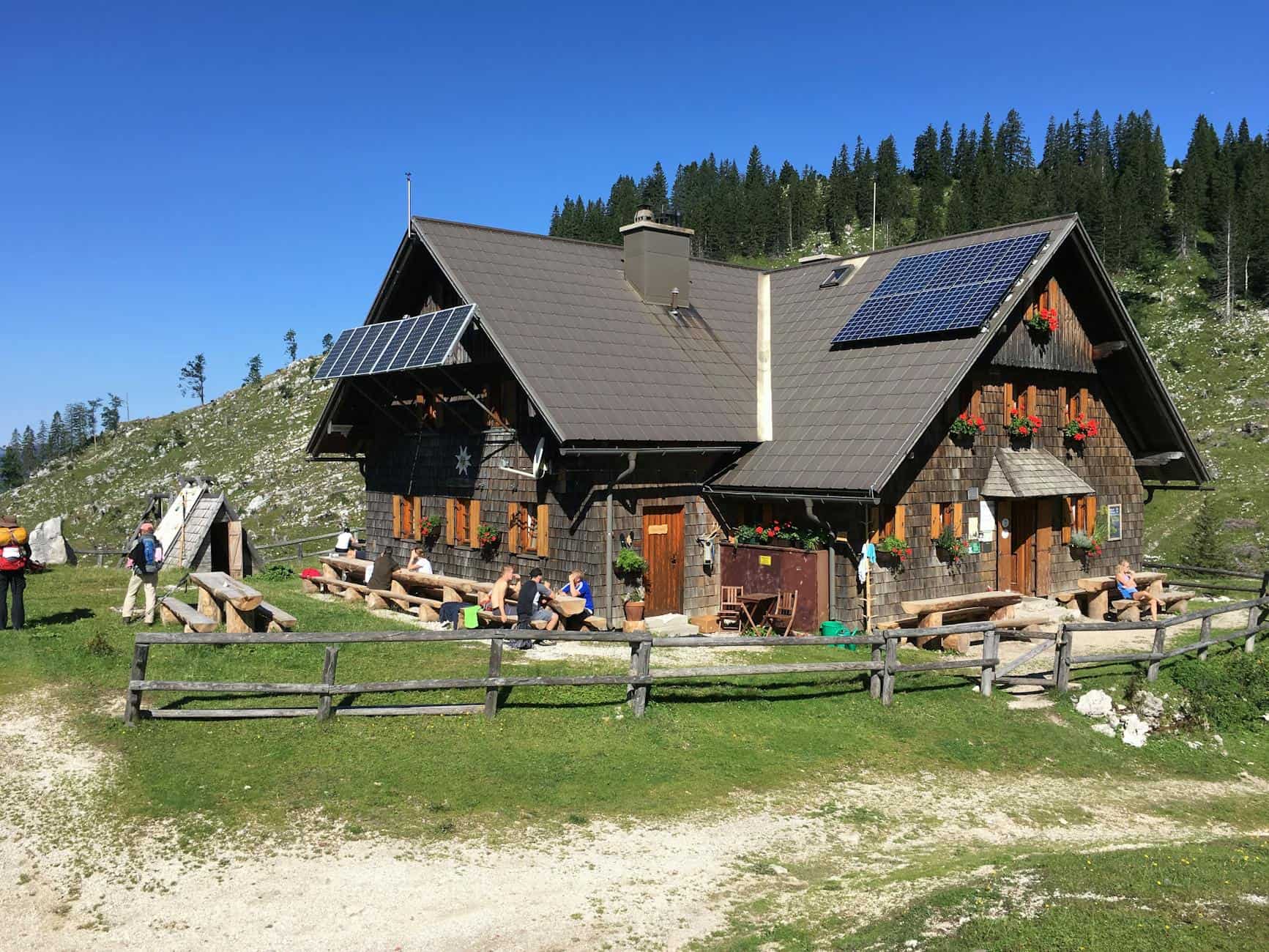 wooden house with solar panels on roof