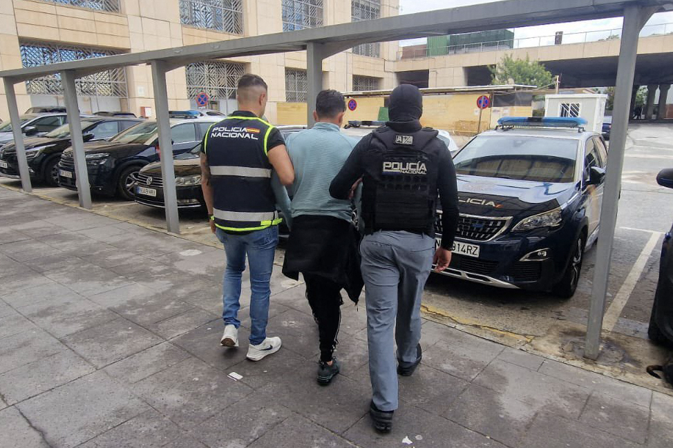 Spanish National Police officers escorting Wilmer Chavarria, alleged leader of Los Lobos.