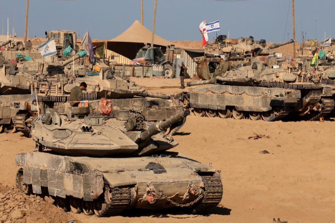 Israeli soldiers sit on top of tanks at a position in the south, near the Israel–Gaza border fence, on Oct. 30, 2025. (AFP Photo)