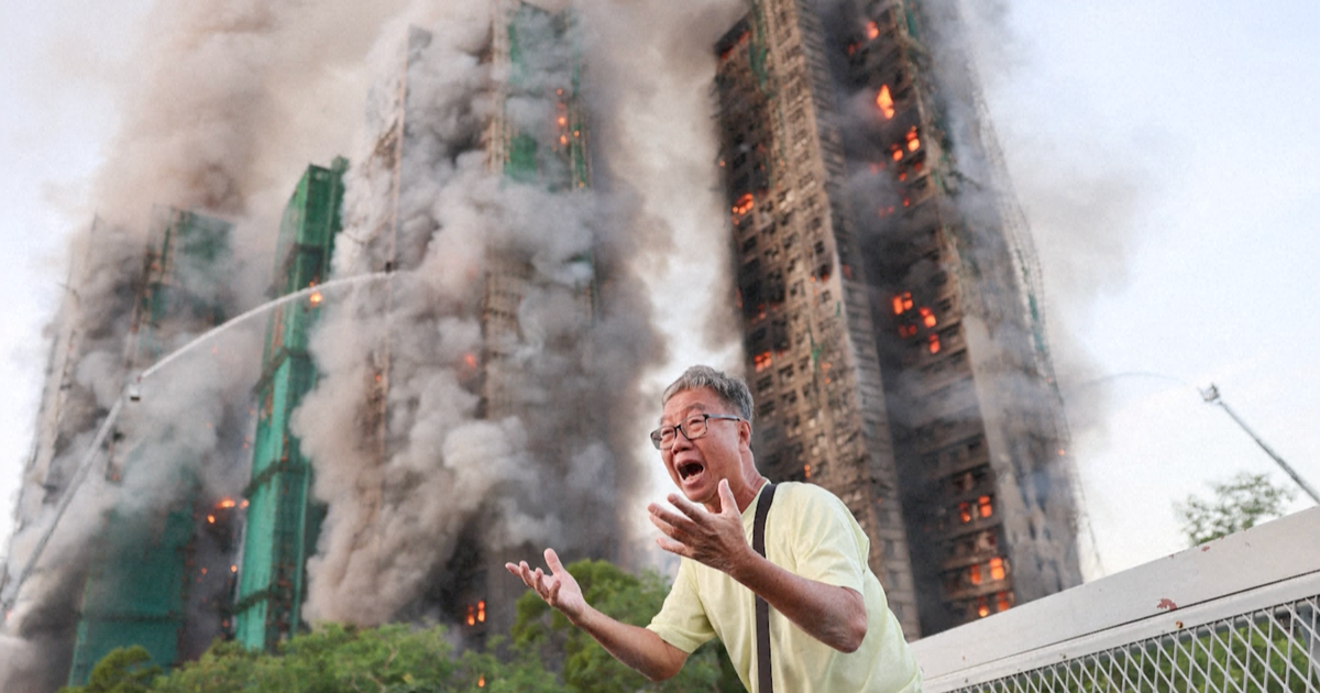 Wong, a 71-year-old man, was photographed in tears outside the burning building claiming his wife was trapped inside.