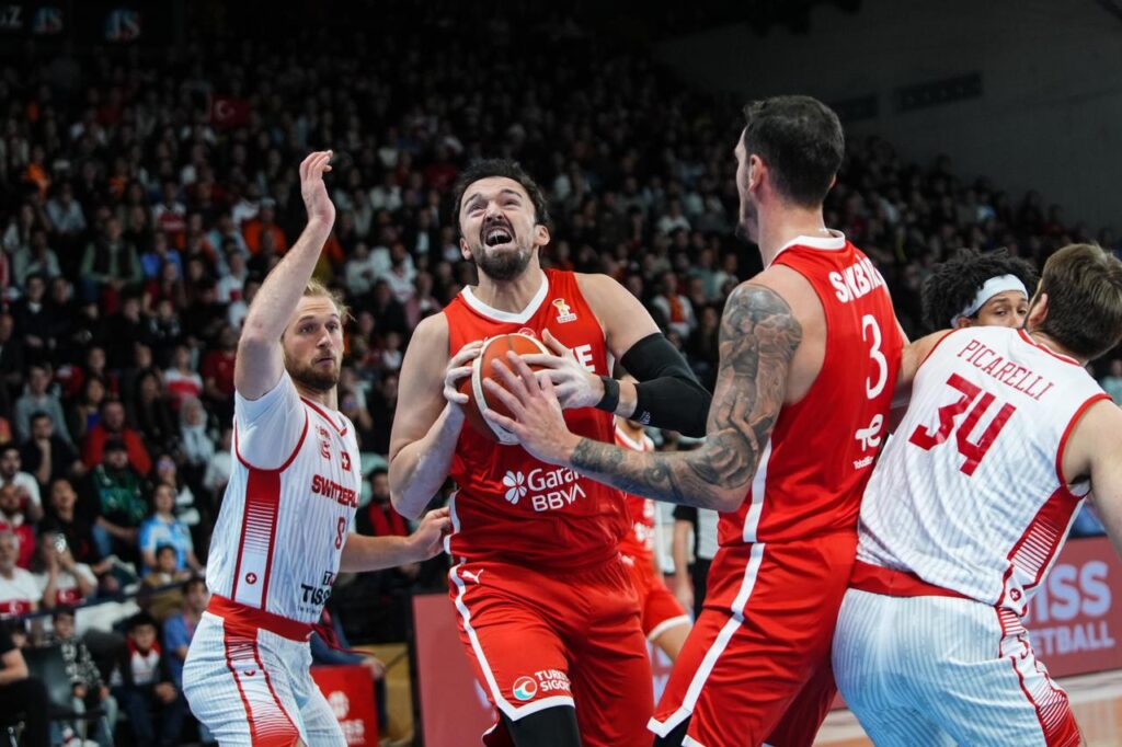 Sertac Sanli (2nd L) of Turkiye in action against Toni Rocak (L) of Switzerland during the FIBA 2027 World Cup European Qualifiers Group C second-round match between Switzerland and Turkiye at Saint-Leonard Sports Hall in Fribourg, Switzerland on Nov. 30, 2025. (AA Photo)