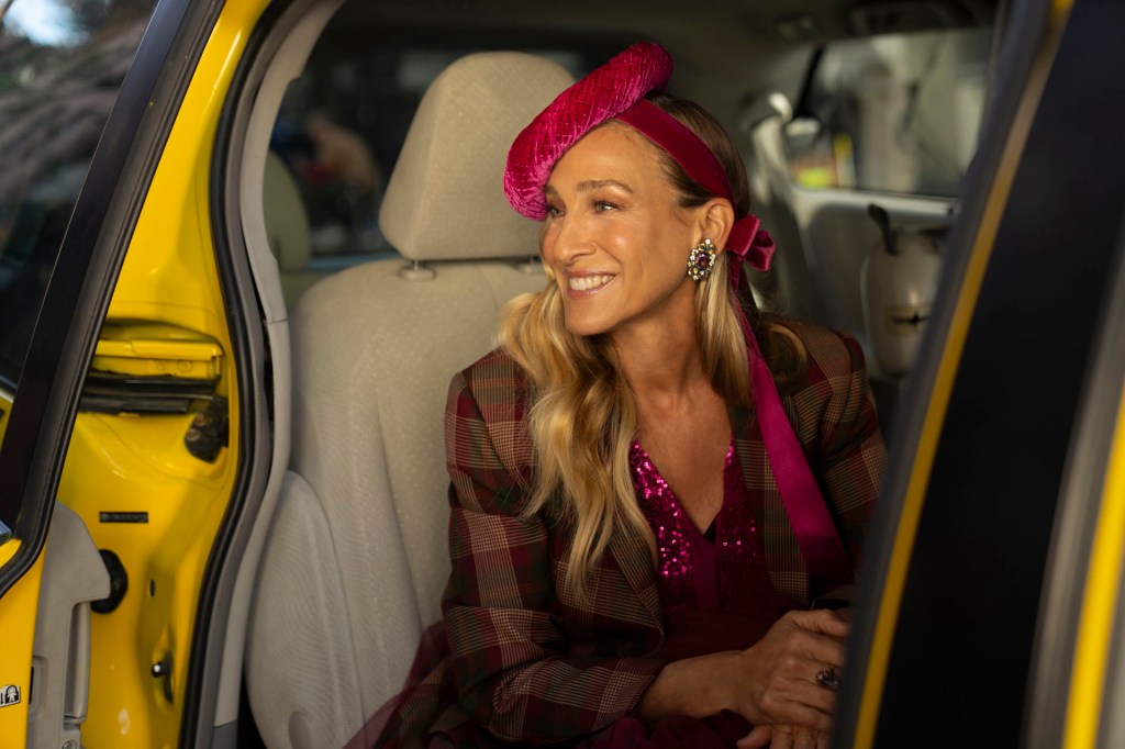 Sarah Parker as Carrie Bradshaw in a taxi.