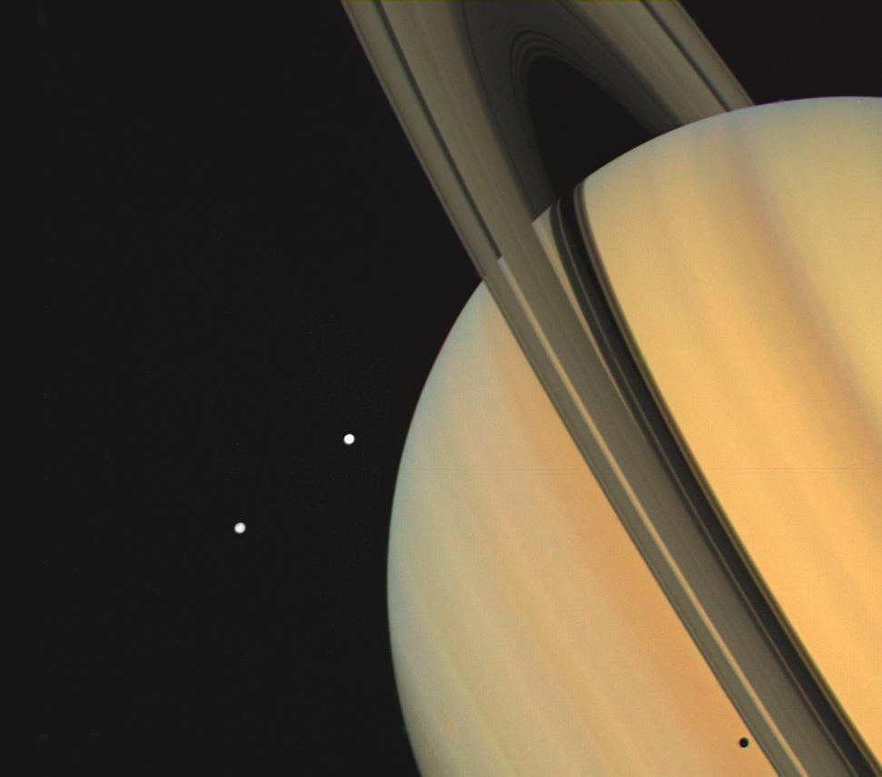 Photograph by Voyager 1 taken on November 3, 1980 of Saturn and two of its moons, Tethys and Dione, from 13 million kilometers (8 million miles).