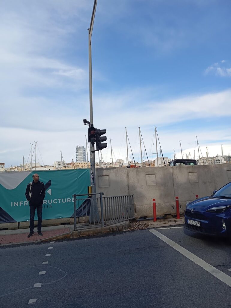 Msida traffic lights once again not working. New "Sidewalk" is just a flooded slipper giant puddle.