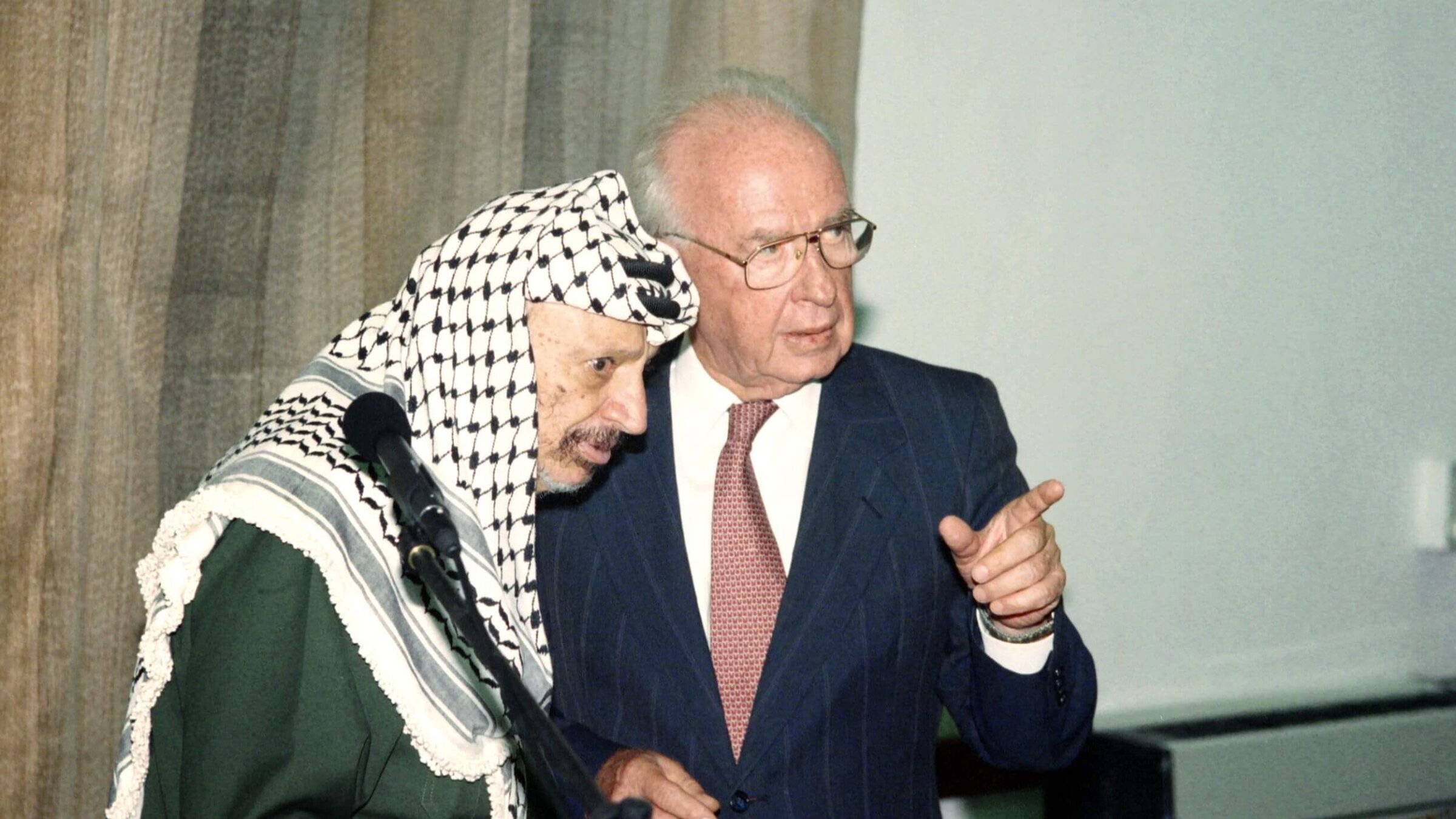 Israeli Prime Minister Yitzhak Rabin (R) speaks to PLO Chairman Yasser Arafat (L) on Sept. 25, 1994.