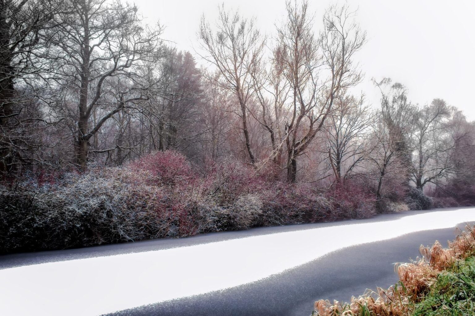 Frozen, snow covered canal