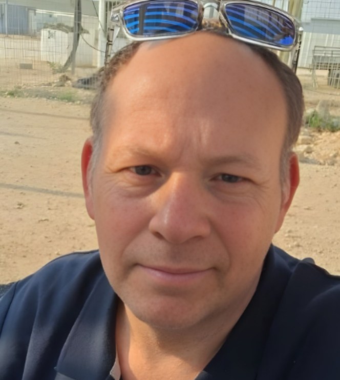 Mordechai Shimshon smiling directly at the camera.