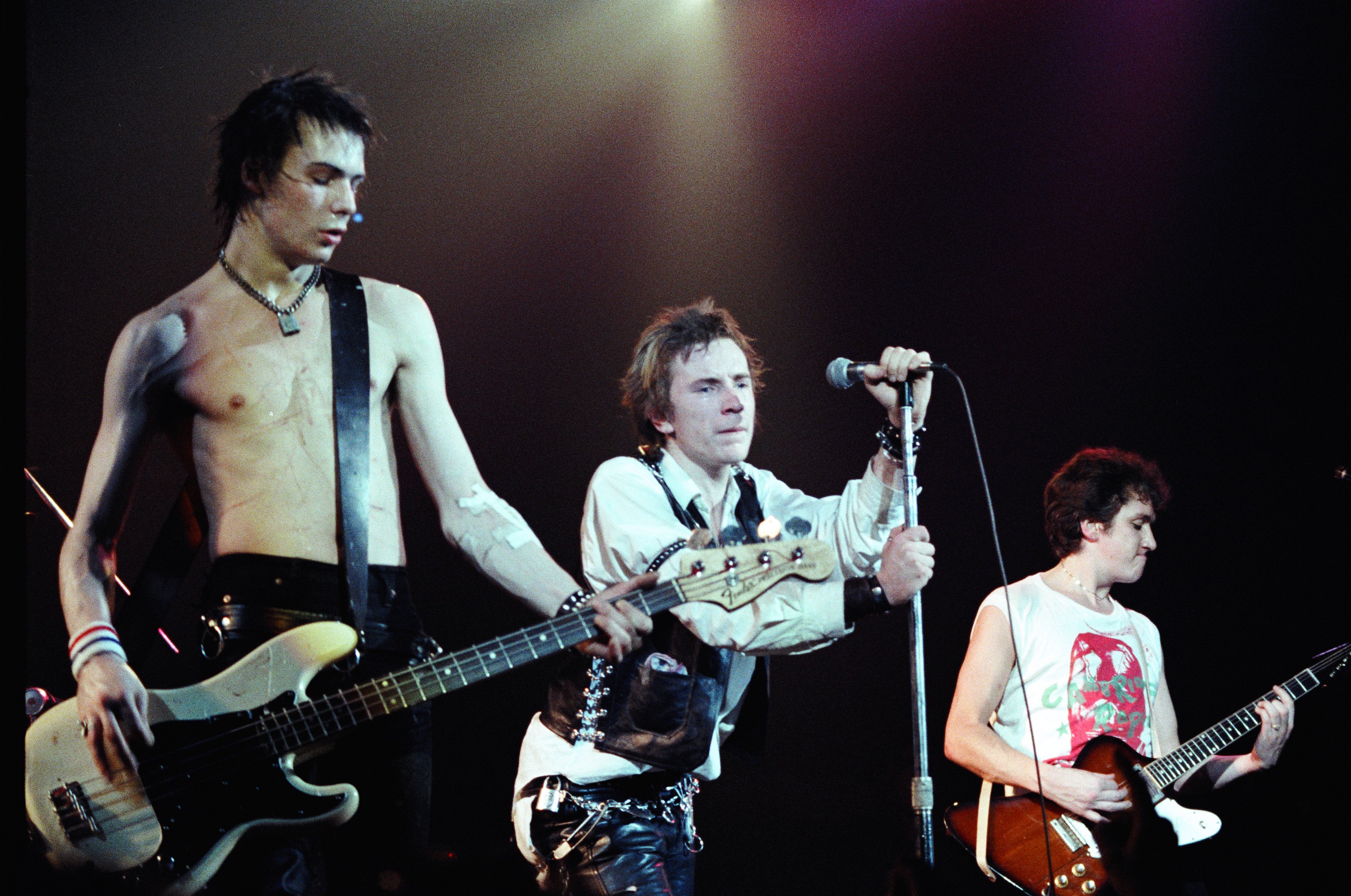 Sid Vicious, Johnny Rotten, and Steve Jones of The Sex Pistols perform live on stage.