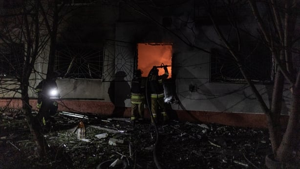 Ukrainian firefighters extinguish a fire in a residential building after a Russian shelling in Druzhkivka, Ukraine