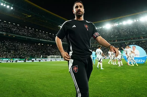 Joao Pereira walks on the pitch.
