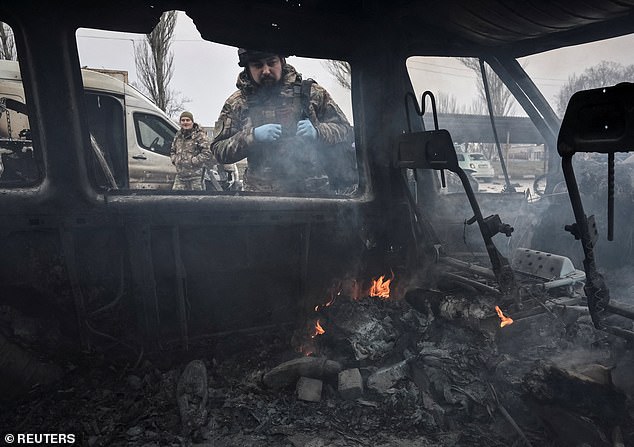 A police officer works at the site of the Russian drone strike, amid Russia's attack on Ukraine, in Zaporizhzhia, Ukraine, December 14, 2025