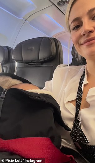 Elsewhere Pixie beamed as she held her son on the plane to Austria