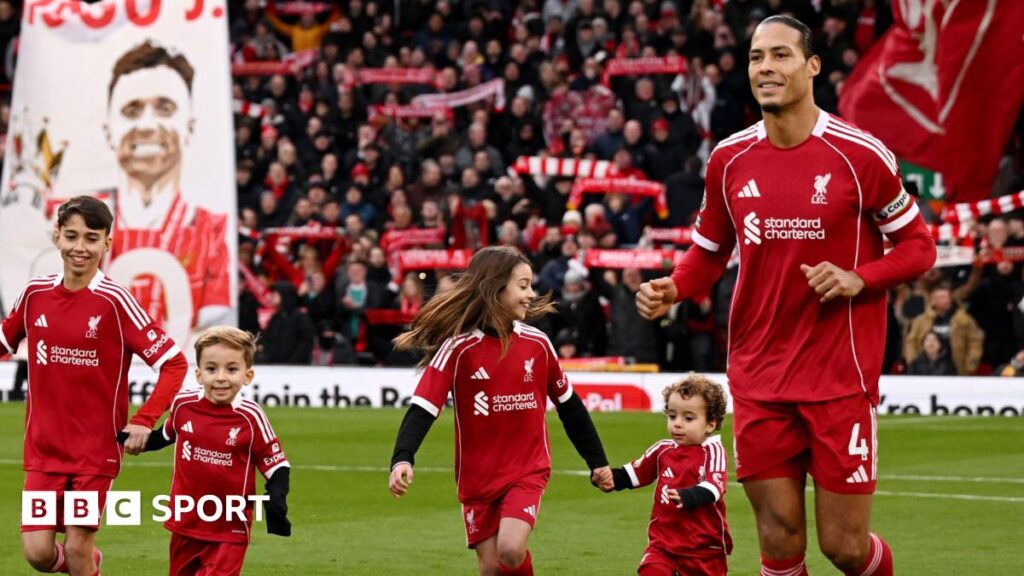Virgil van Dijk of Liverpool enters the pitch with the children of former player Diogo Jota prior to the Premier League match between Liverpool and Wolves