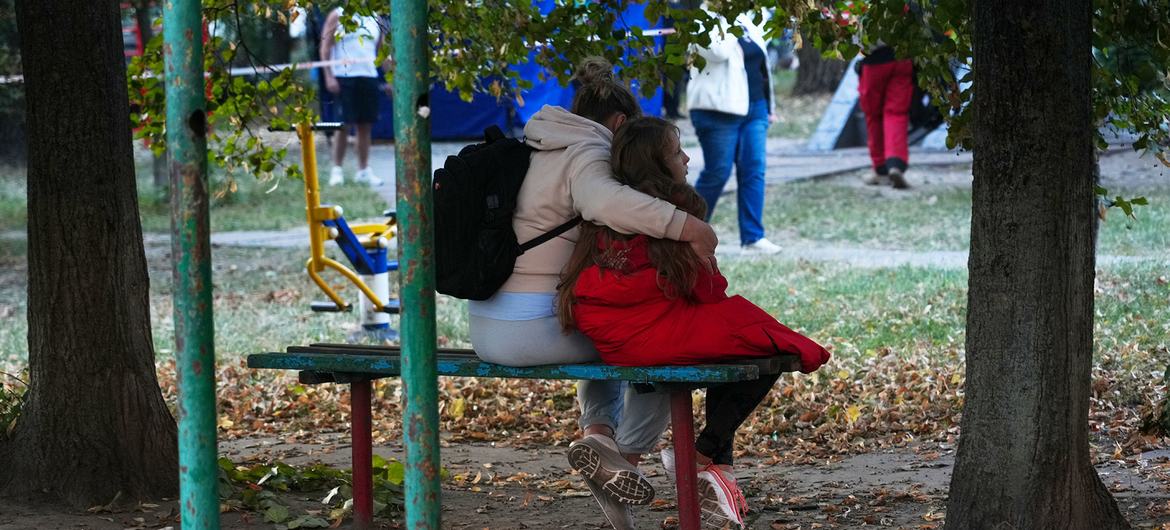  A woman embraces a girl near a residential building struck by missiles in Kyiv, Ukraine.