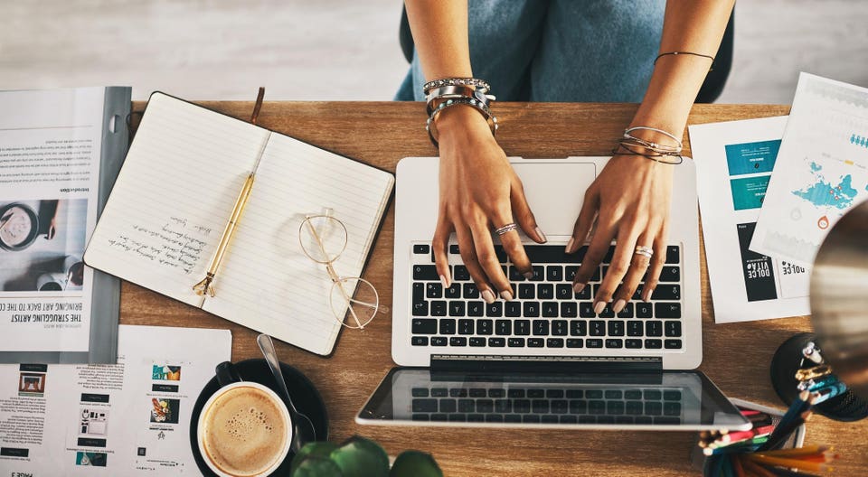 Shot of an unrecognisable businesswoman using a laptop while working remotely