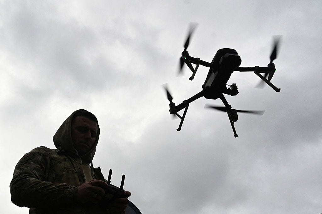 A person operates a flying drone.
