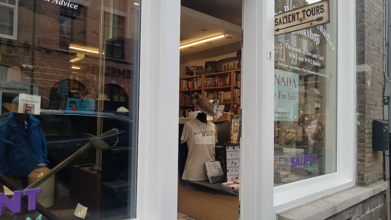 A window to a store with a sign in it that says 'Canada is not for sale but this shop is'