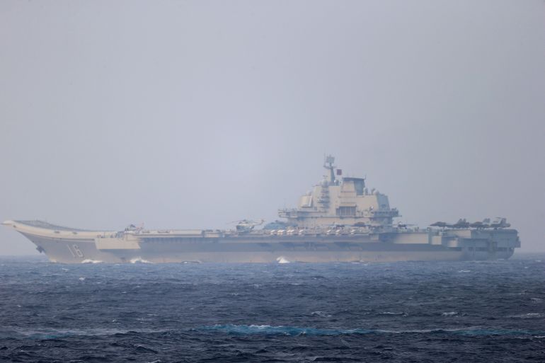 FILE PHOTO: Chinese aircraft carrier Liaoning sails through the Miyako Strait near Okinawa on its way to the Pacific in this handout photo taken by Japan Self- Defence Forces and released by the Joint Staff Office of the Defence Ministry of Japan on April 4, 2021. Joint Staff Office of the Defence Ministry of Japan/HANDOUT via REUTERS ATTENTION EDITORS - THIS IMAGE WAS PROVIDED BY A THIRD PARTY. MANDATORY CREDIT. THIS PICTURE WAS PROCESSED BY REUTERS TO ENHANCE QUALITY. AN UNPROCESSED VERSION HAS BEEN PROVIDED SEPARATELY/File Photo