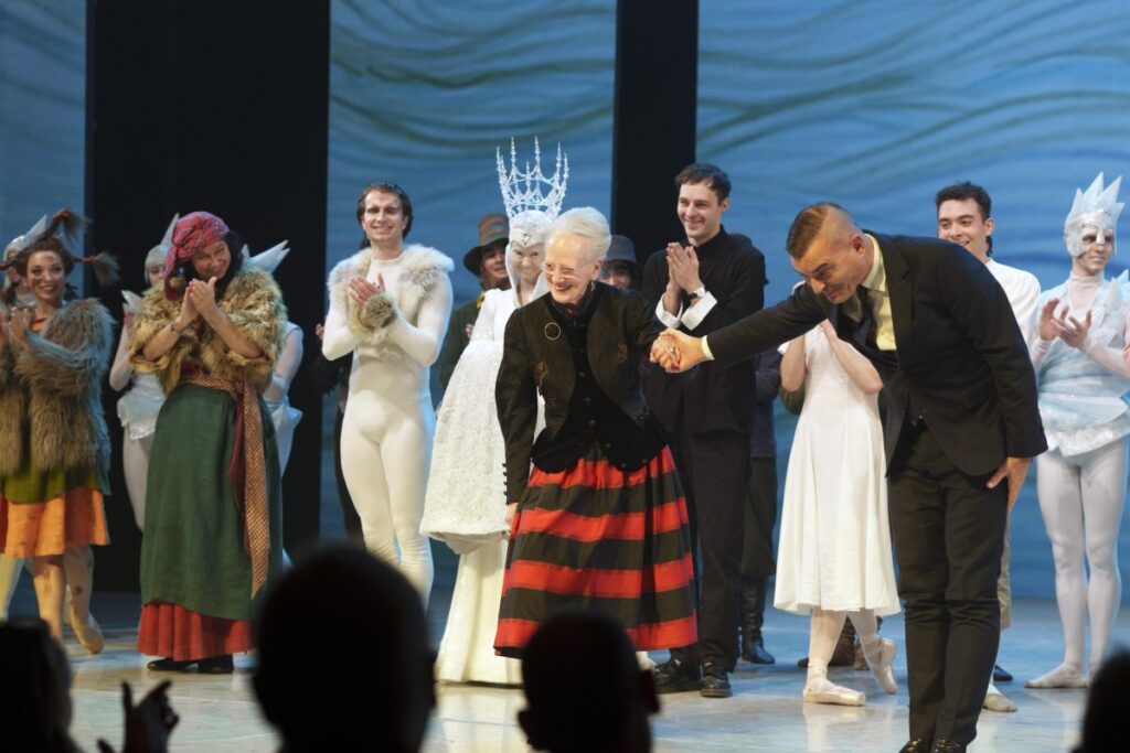 Queen Margrethe of Denmark takes a bow with the cast of this year