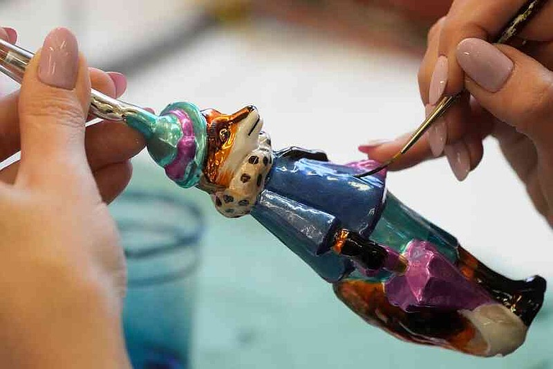 A worker prepares a hand-made Christmas bauble at GlitterLab in Czestochowa, southern Poland, on Nov. 21, 2025. (AP Photo/Czarek Sokolowski)