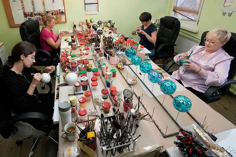 Workers prepare the hand-made Christmas baubles at GlitterLab in Czestochowa, southern Poland, on Nov. 21, 2025.