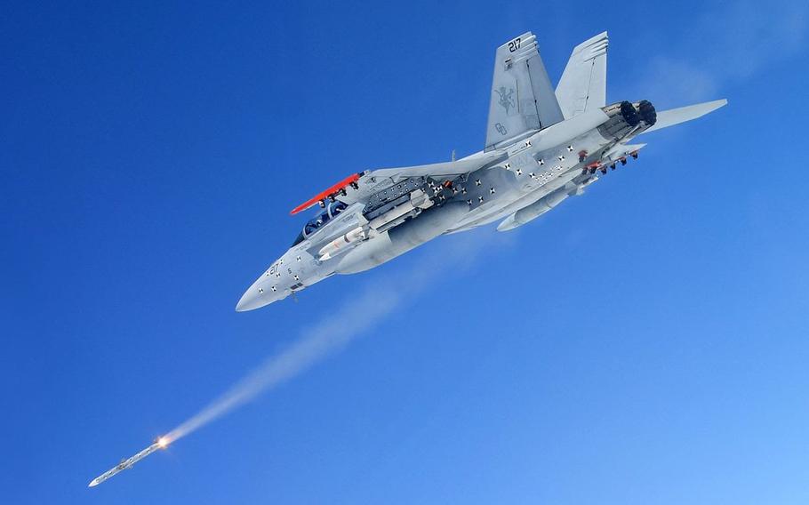 A fighter jet fires a missile.
