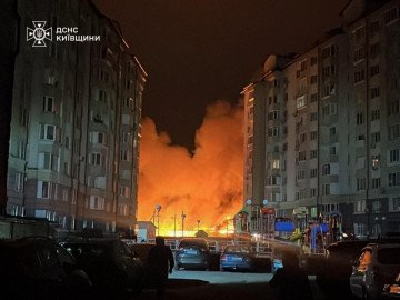 Flames and smoke rise from a burning facility between residential buildings in the Kyiv region after an overnight Russian strike. (Source: DSNS Kyiv)