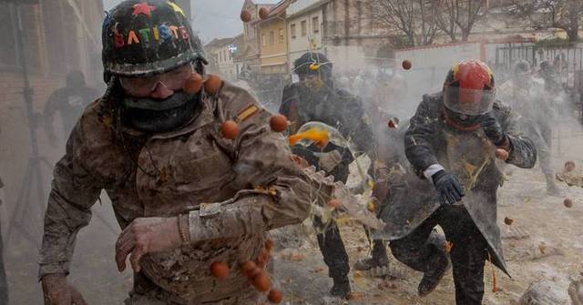 Photos show flour, eggs and firecrackers flying at Spain’s Els Enfarinats festival Photos show flour, eggs and firecrackers flying at Spain's Els Enfarinats festival