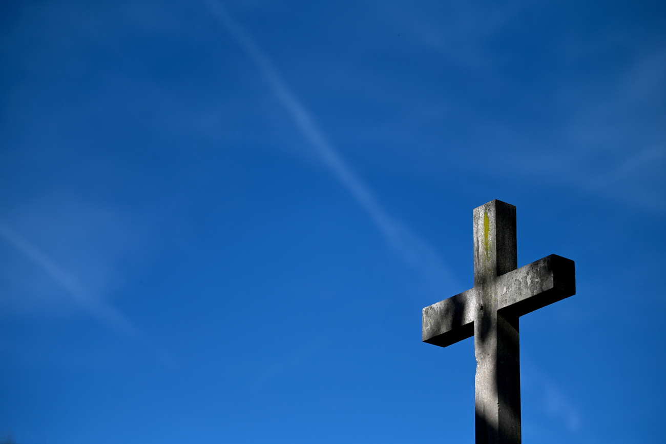A cross against a blue background.
